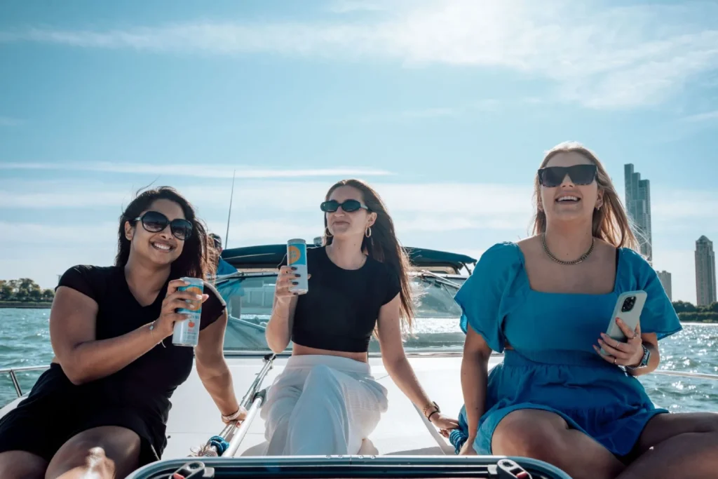 Friends enjoying drinks and sunshine on a private boat at the Chicago Playpen
