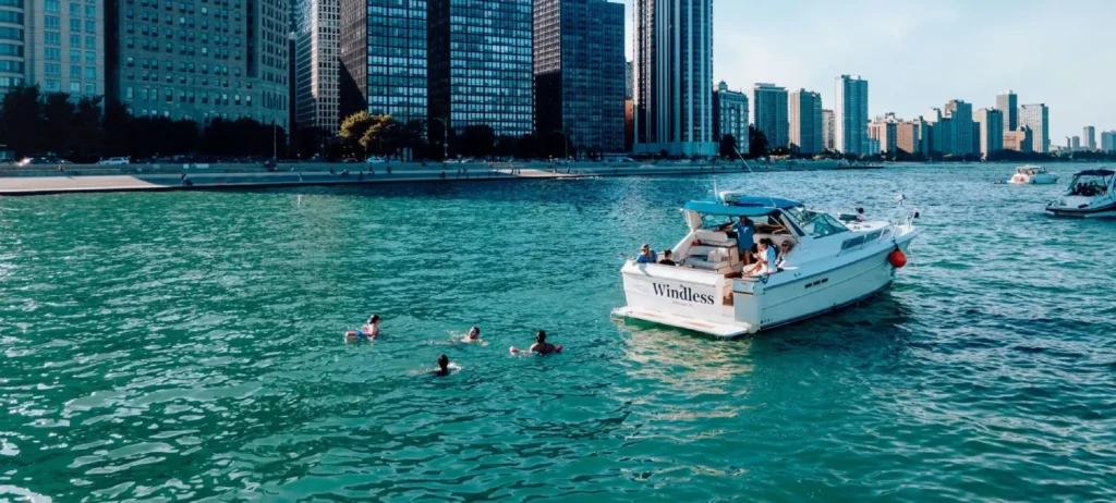Guests swimming and relaxing at the Chicago Playpen during a private boat charter on Lake Michigan