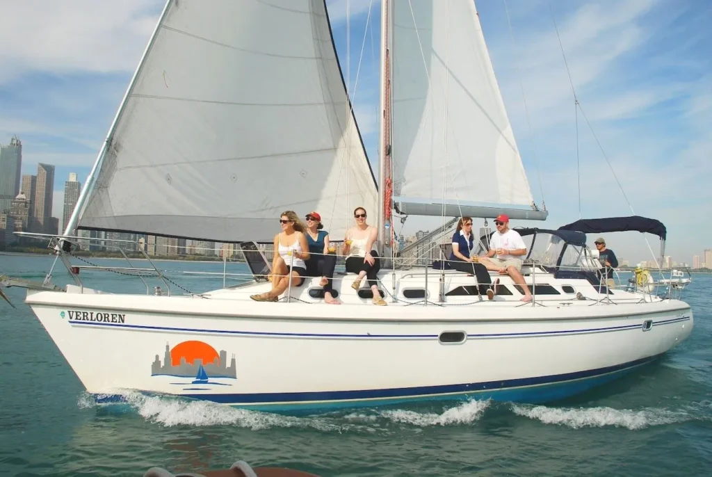 Luxury sailboat cruising on Lake Michigan with guests relaxing on deck in Chicago