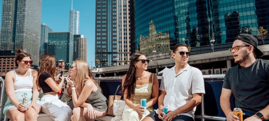 Guests enjoying a private Chicago River cruise with downtown skyscrapers in the background