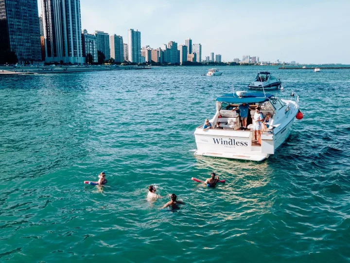 Guests enjoying a daytime yacht rental on Lake Michigan with a swim stop in Chicago