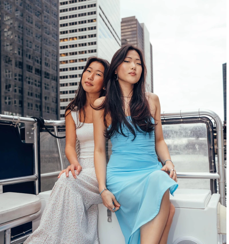 Friends posing on the back of a boat during a bachelorette party on the Chicago River