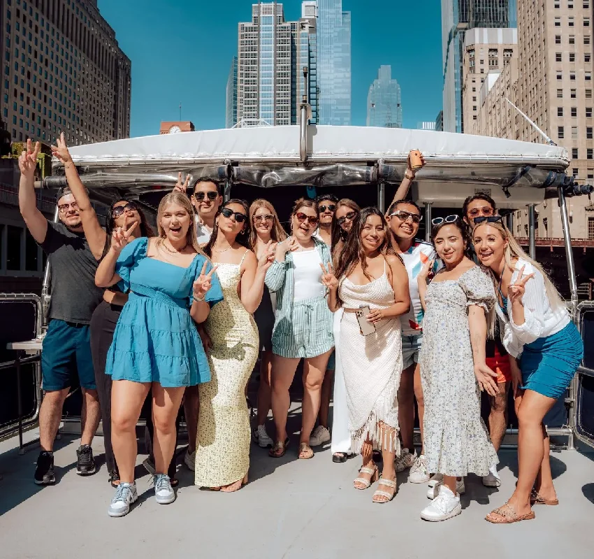 Group posing together on a party boat rentals Chicago cruise through downtown