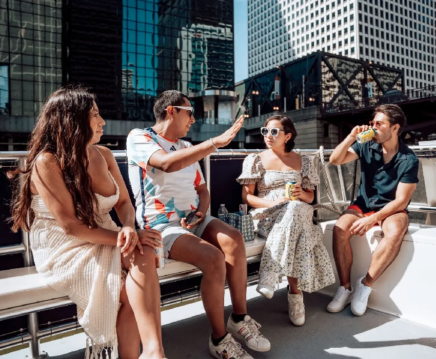 Friends relaxing on a party boat for rent in Chicago during a river cruise