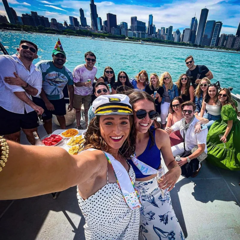 Group selfie on a Playpen Chicago boat rental with the Chicago skyline in the background.