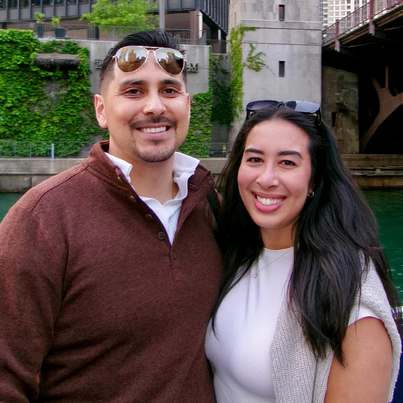 A happy couple on a captained boat rental in Chicago passing the city's famous architecture.