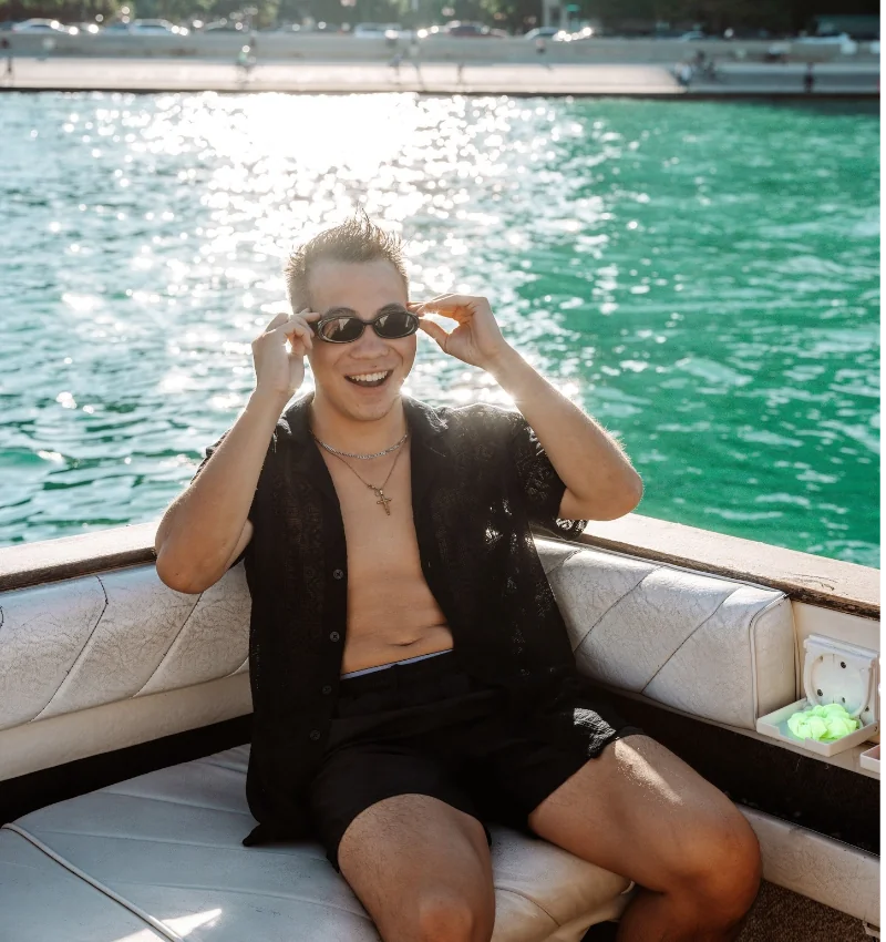 Guest enjoying a private boat tour in Chicago on the water on a sunny day.