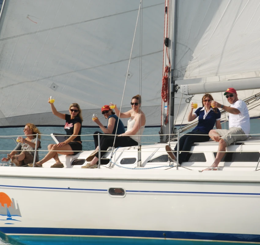 Friends toasting on a private sailboat rentals Chicago experience on Lake Michigan