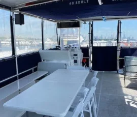 Interior seating and table setup on a big boat charter in Chicago