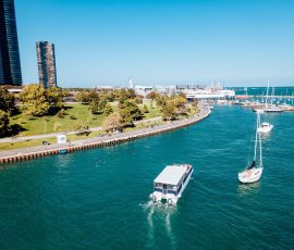Aerial view of a boat cruise departing Chicago Harbor along the Lake Michigan shoreline