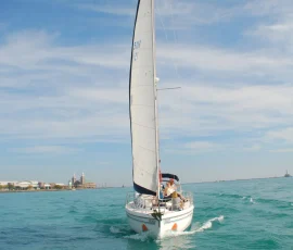 Sailboat rental sailing on Lake Michigan with Chicago in the background