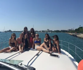 Friends enjoying drinks on the deck of a luxury yacht rental in Chicago