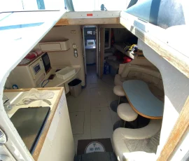 Interior cabin entry of a premium yacht charter in Chicago showing dining area and galley below deck