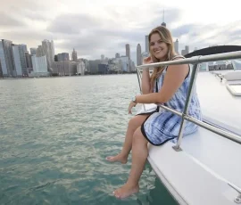 Woman smiling during a private boat rental with Chicago skyline views